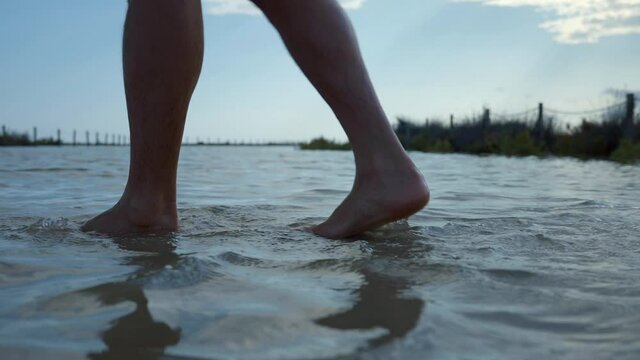 Male Feet Crossing Flooded Area, Static Shot
