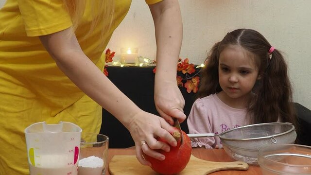 Mam And Daughter Are Making Dough pie For Thanksgiving Pie. put the dough in a mold for a thanksgiving pumpkin pie. Process of making Pumpkin pie for Thanksgiving Day. Seasonal traditional autumn fest