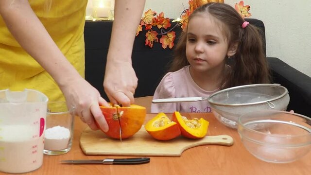 Mam And Daughter Are Making Dough pie For Thanksgiving Pie. put the dough in a mold for a thanksgiving pumpkin pie. Process of making Pumpkin pie for Thanksgiving Day. Seasonal traditional autumn fest
