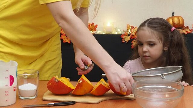 Mam And Daughter Are Making Dough pie For Thanksgiving Pie. put the dough in a mold for a thanksgiving pumpkin pie. Process of making Pumpkin pie for Thanksgiving Day. Seasonal traditional autumn fest