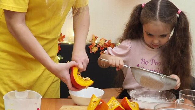 Mam And Daughter Are Making Dough pie For Thanksgiving Pie. put the dough in a mold for a thanksgiving pumpkin pie. Process of making Pumpkin pie for Thanksgiving Day. Seasonal traditional autumn fest