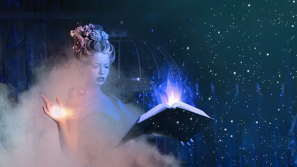 Christmas fairy tale concept. Snow queen calling winter use book of spells