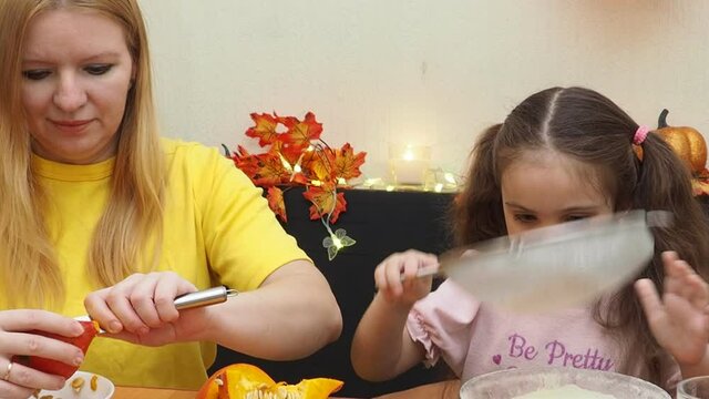 Mam And Daughter Are Making Dough pie For Thanksgiving Pie. put the dough in a mold for a thanksgiving pumpkin pie. Process of making Pumpkin pie for Thanksgiving Day. Seasonal traditional autumn fest