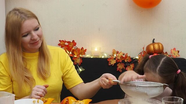 Mam And Daughter Are Making Dough pie For Thanksgiving Pie. put the dough in a mold for a thanksgiving pumpkin pie. Process of making Pumpkin pie for Thanksgiving Day. Seasonal traditional autumn fest