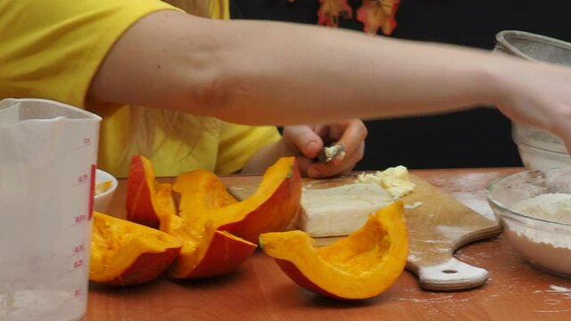 Mam And Daughter Are Making Dough pie For Thanksgiving Pie. put the dough in a mold for a thanksgiving pumpkin pie. Process of making Pumpkin pie for Thanksgiving Day. Seasonal traditional autumn fest