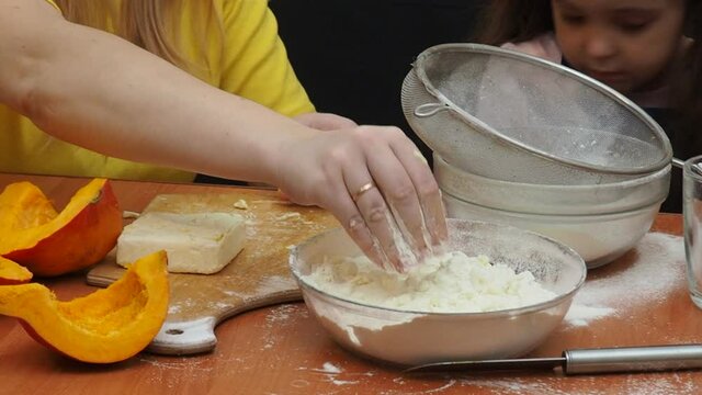 Mam And Daughter Are Making Dough pie For Thanksgiving Pie. put the dough in a mold for a thanksgiving pumpkin pie. Process of making Pumpkin pie for Thanksgiving Day. Seasonal traditional autumn fest