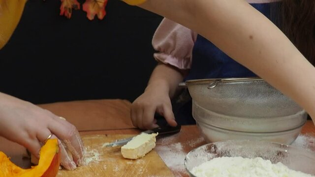 Mam And Daughter Are Making Dough pie For Thanksgiving Pie. put the dough in a mold for a thanksgiving pumpkin pie. Process of making Pumpkin pie for Thanksgiving Day. Seasonal traditional autumn fest