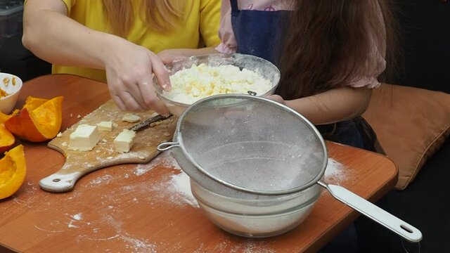 Mam And Daughter Are Making Dough pie For Thanksgiving Pie. put the dough in a mold for a thanksgiving pumpkin pie. Process of making Pumpkin pie for Thanksgiving Day. Seasonal traditional autumn fest