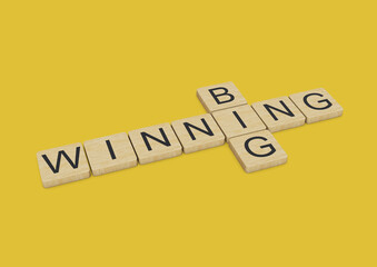 Big Winning written with wooden letters on yellow background