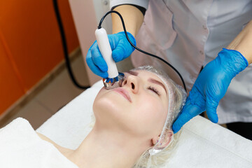 Naklejka premium Hardware cosmetology. Facial skin care in the spa salon.