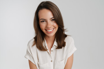 Obraz premium Young european woman in shirt smiling and looking at camera