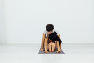 woman and man engaged in paired gymnastics yoga asana