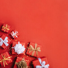 Gift boxes with white and brown bows on a red backdrop.