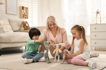 Happy grandmother and her grandchildren spending time together at home