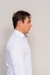 Profile view portrait of handsome Persian man against plain background