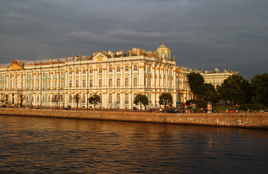 The State Hermitage Museum in Saint Petersburg at sundown with dark clouds