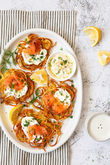 Hash brown potato with smoked salmon, dill and white sauce. Potato Pancakes. delicious Vegetable fritters. Potato patties or hash browns. Crispy potatoes