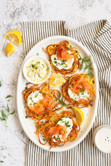 Hash brown potato with smoked salmon, dill and white sauce. Potato Pancakes. delicious Vegetable fritters. Potato patties or hash browns. Crispy potatoes