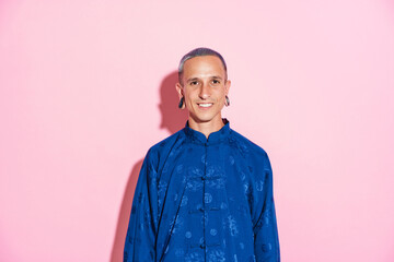 Fototapeta premium Young white man in chinese jacket smiling and looking at camera