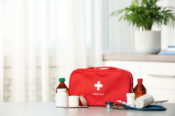 First aid kit on table indoors, space for text