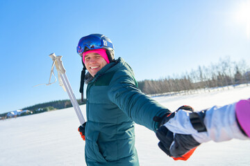 Fototapeta na wymiar Young couple having fun while winter skiing