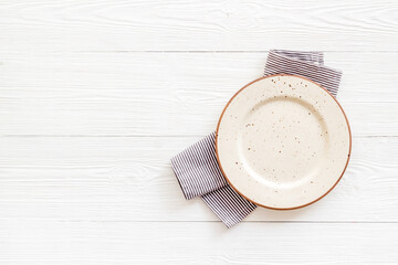 Table setting top view. Empty plate on napkin - dishware for dinner
