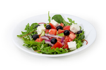 Greek salad on white dish on a white background