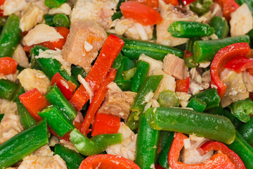 Salad with boiled chicken and vegetables close-up, background