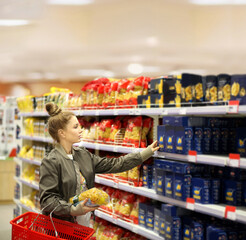 Woman choosing a dairy products at supermarket