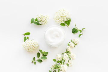 Herbal facial cream cosmetic for skin care with white flowers