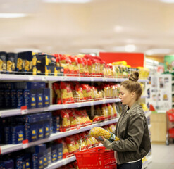 Woman choosing a dairy products at supermarket