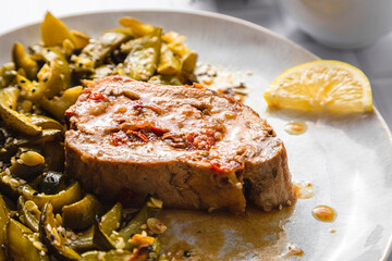 Roasted stuffed pork loin with lemon zucchini salad in plate