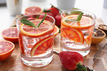 Orange punch with green mint served with strawberry on wooden table