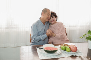 Portrait of happy couple senior asia woman and retirement man having breakfast together