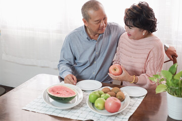 Obraz na płótnie Canvas Portrait of happy couple senior asia woman and retirement man having breakfast together