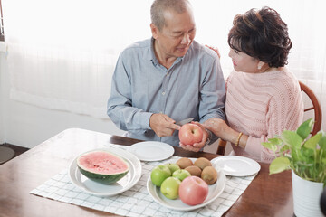 Obraz na płótnie Canvas Portrait of happy couple senior asia woman and retirement man having breakfast together