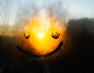 smile on a frosted window with the morning sun in the background. smiley - Powered by Adobe