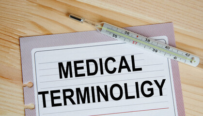 On the sheet from the diary there is the text MEDICAL TERMINOLIGY, next to the thermometer.