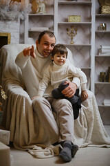 father with little son christmas interior studio