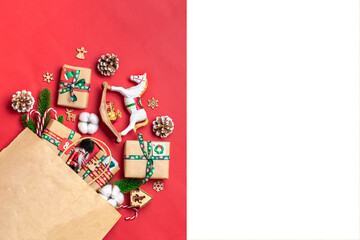 Handmade wrapped red, green gift boxes decorated with ribbons, snowflakes and numbers, Christmas decorations and decor in bag on red table Xmas advent calendar concept Top view Flat lay Holiday card