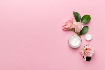 Composition with cosmetic products and beautiful roses on color background. Copy space, flat lay