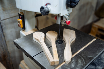 The process of creating wooden spoons. From a bar of wood to a spoon. Installation for sawing boards. Equipment in the carpentry workshop.