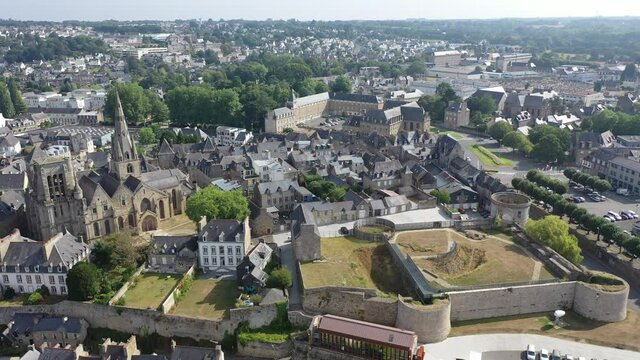 Flight over the city Guingamp and Basilica of Our Lady of Merciful on summer day. France