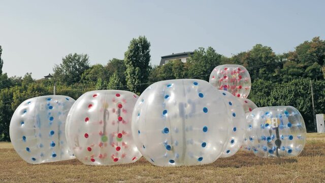Plastic zorbing ball. close-up. rolling zorbs. Zorbing Balls on a Playground. large transparent plastic spheres, orbs or zorbs, outdoors in the park.