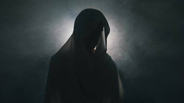 Man in mantle in the dark