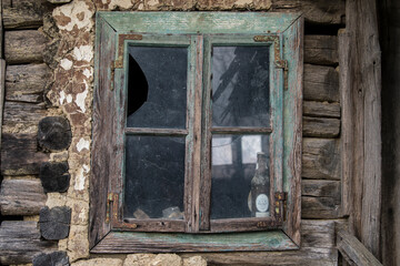 Sunja,Croatia,05,04,2021. Rustic style aged window in wooden village rural home wall.