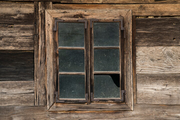 Sunja,Croatia,05,04,2021. Rustic style aged window in wooden village rural home wall.
