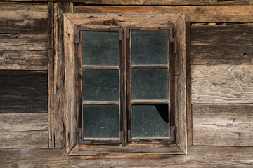 Obraz na płótnie Canvas Sunja,Croatia,05,04,2021. Rustic style aged window in wooden village rural home wall.