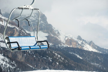 Ski lift chairs in winter mountains