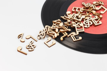Vinyl record and wooden musical notes